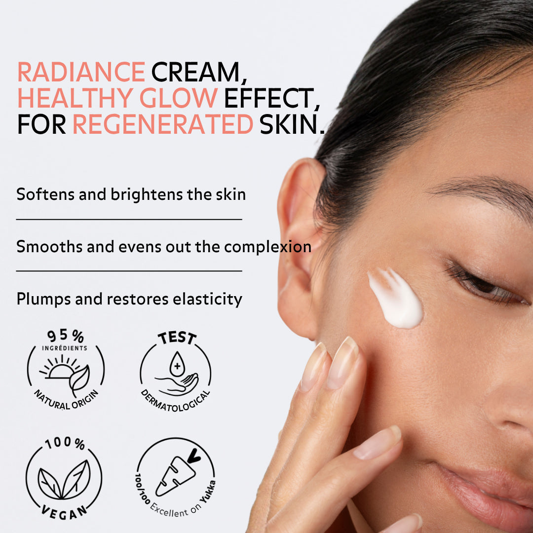 Close-up of a woman applying cream to her cheek with text highlighting benefits: radiance cream for regenerated skin, softens and brightens, smooths and evens complexion, plumps and restores elasticity. Icons indicate 95% natural ingredients, dermatologically tested, vegan, and excellent Yuka rating.
